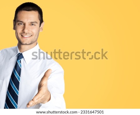 Businessman in white shirt and tie, giving hand for handshake, isolated over orange yellow colour background. Success in business, wellcome concept. Studio portrait of man in confident clothing.