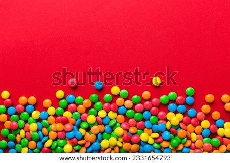 Mixed collection of colorful candy, on colored background. Flat lay, top view. frame of colorful chocolate coated candy. Royalty-Free Stock Photo #2331654793