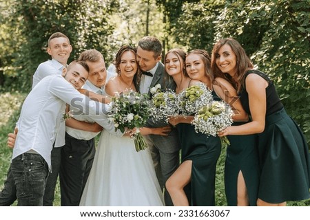 The bride and groom celebrate their wedding with friends outdoors after the ceremony Royalty-Free Stock Photo #2331663067