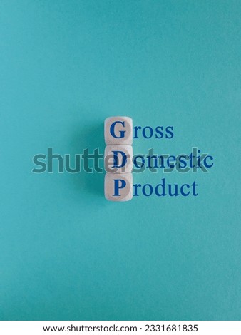 Gross domestic product symbol. Wooden cubes with blue words GDP. Beautiful blue background. Copy space. Business and growth of GDP, gross domestic product concept.