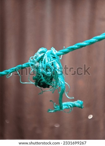 clothespins and stretched rope with a blurred background