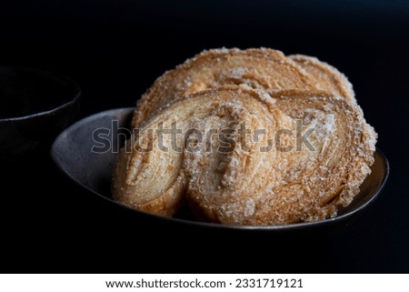 Close up Traditional French pastry , Palmiers, on Black background