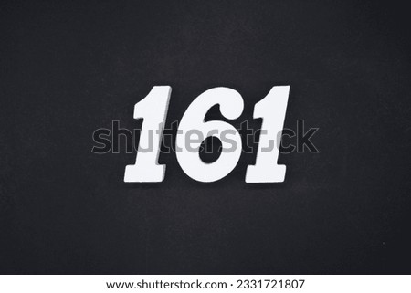 Black for the background. The number 161 is made of white painted wood.