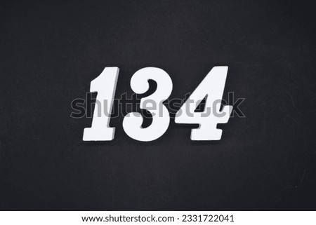 Black for the background. The number 134 is made of white painted wood.