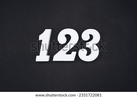 Black for the background. The number 123 is made of white painted wood.