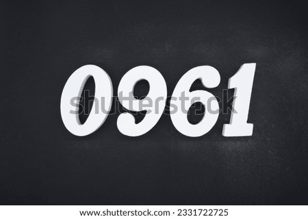 Black for the background. The number 0961 is made of white painted wood.
