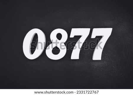 Black for the background. The number 0877 is made of white painted wood.