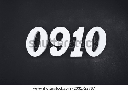 Black for the background. The number 0910 is made of white painted wood.
