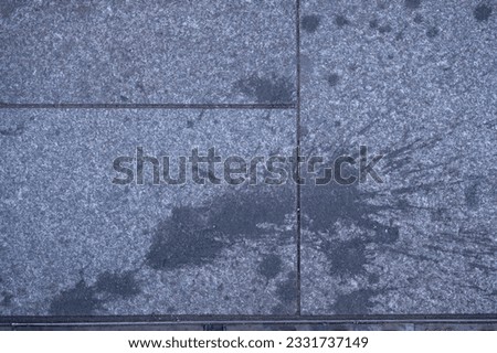 dirty pavement stone block, food or drink splash on ground