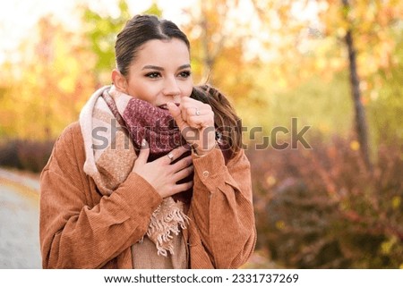 Caucasian young woman coughing during autumn. Royalty-Free Stock Photo #2331737269
