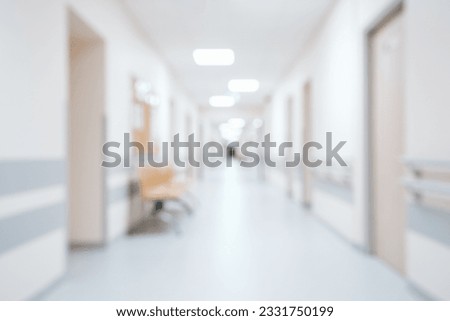 Bright, empty defocused hospital corridor background with copy space Royalty-Free Stock Photo #2331750199