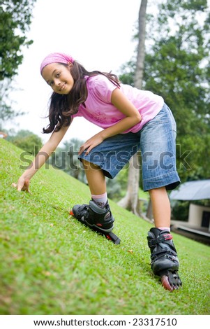 Young girl enjoying the outdoor park in her rollerblade