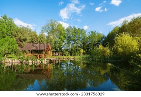 Wooden house and pond at the sunrise