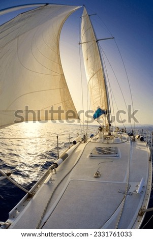 people on a sail boat at the sunset