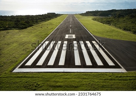 Aerial view of paved airplane runway on Maui, Hawaii.