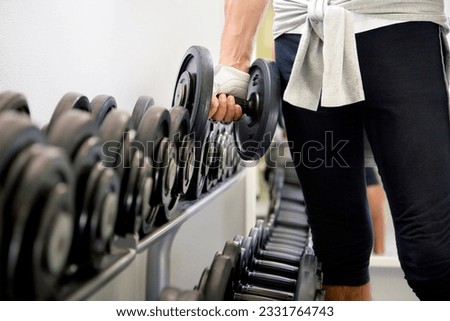 health club- guy in a gym doing weight lifting