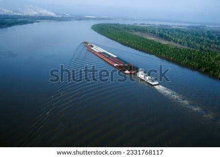 Aerial of barge on Mississippi River in Baton Rouge, Louisiana. Royalty-Free Stock Photo #2331768117