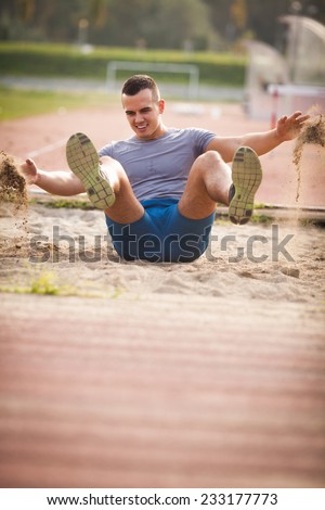 Young athlete performing long jump