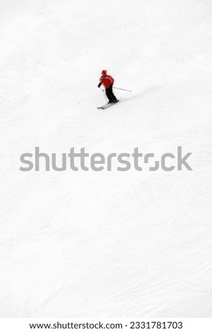 winter scene- man moving down from the top of the mountain. The skier is motion blurred