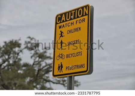 A Caution Sign to watch for Children, Joggers, Bicyclists and Pedestrians.