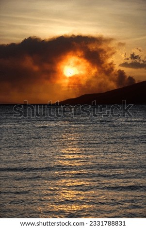 Dark clouds at sunset over water on Maui, Hawaii.