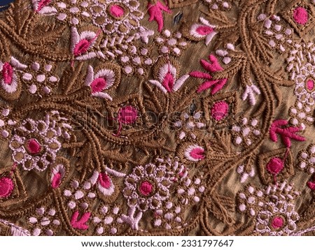 Brown and pink cut out embroidered lace on cotton fabric 