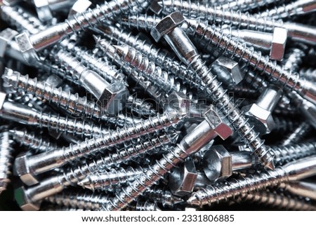 Galvanized large wood screws in a heap close-up. Royalty-Free Stock Photo #2331806885
