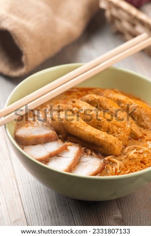 Hot and spicy Singaporean Curry Noodle or laksa mee, serve with chopsticks. Singapore cuisine.