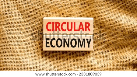 Circular economy symbol. Concept words Circular economy on wooden blocks. Beautiful canvas table canvas background. Business circular economy concept. Copy space.