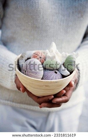 woman holding bowl with sea-urchins