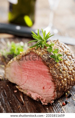 nice piece of roasted siroin beef covered in herbs
