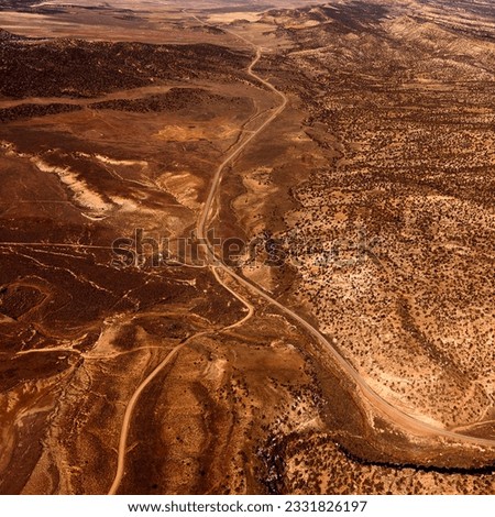 Aerial view of a of rural, desert landscape with roads running through it. Square shot.