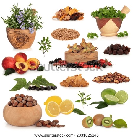 Healthy super food collection of fresh and dried fruit, herbs, pulses and nuts, very high in antioxidants and vitamins, isolated over white background.