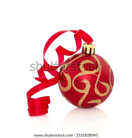 Red and gold sparkling christmas bauble with ribbon, isolated over white background.
