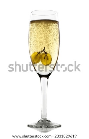 Grapes floating in champagne glass creating lots of bubbles