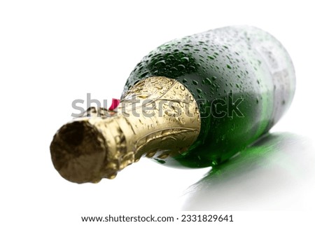 Cold wet bottle of champagne wine on white background