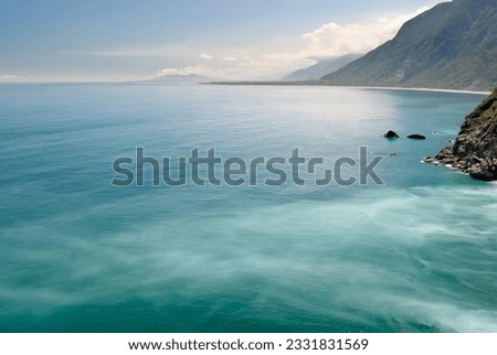 Seascape of cliff with beautiful ocean under blue sky.