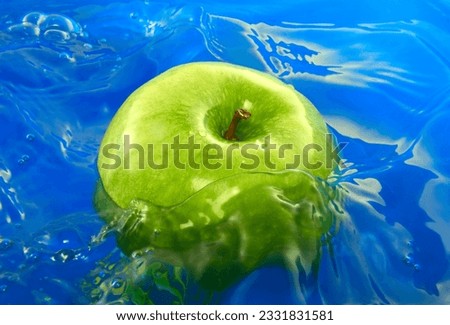 Green apple in the blue water