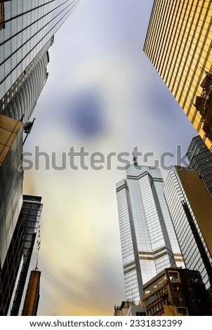 Colorful skyscrapers and city skyline with dramatic clouds in Hong Kong, Asia.