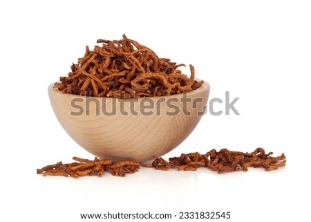 Senega root in a beech wood bowl and scattered isolated over white background. Used in chinese herbal medicine to treat respiratory problems. Yuan zhi. Radix polygalae tenufoliae.
