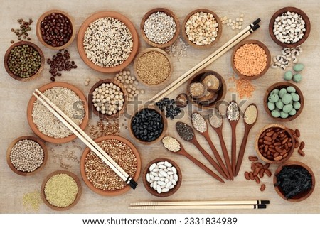Macrobiotic diet healthy food sampler with cereals, grains, wakame seaweed, legumes, seeds, wasabi nuts and vegetables with foods high in fiber, antioxidants and minerals. Top view on natural hemp pap