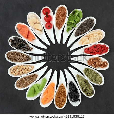 Health food concept to boost brain power and promote memory in porcelain dishes on slate background. Foods high in omega 3, antioxidants, anthocyanins, vitamins and minerals. Top view.