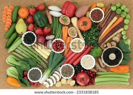 Superfood for healthy diet concept with fresh vegetables, fruit, legumes, seeds, grains and cereals with foods high in omega 3, anthocyanins, antioxidants, dietary fiber, vitamins and minerals. Top vi