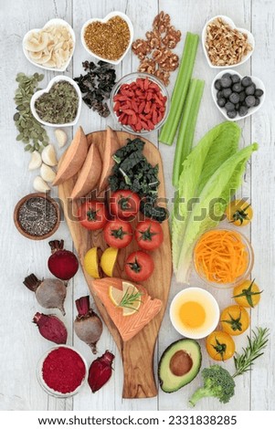 Healthy eating concept to improve brain power and memory on rustic wood background. Super food high in minerals, vitamins, antioxidants, omega 3 and anthocyanins. Top view.