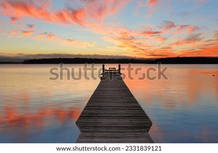 Sunset over the St Georges Basin with beautifully restored timber jetty. This jetty was destroyed in the recent floods of August 2015