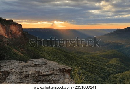 Beauitiful sunrise in the Blue Mountains from Katoomba sunrays stream into Jamison Valley
