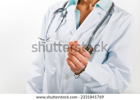 healthcare and medicine- young doctor taking temperature