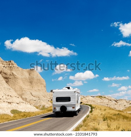 Recreational vehicle on scenic road in Badlands National Park, North Dakota.