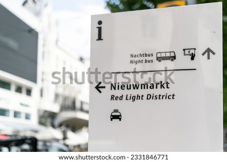A street sign in Amsterdam, Netherlands directs people towards Centraal Station and the red light district.