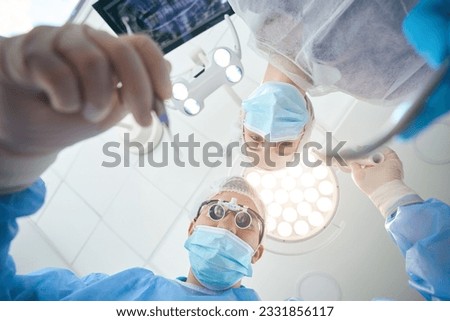 Surgeon dentist in special lenses at workplace inoperating room Royalty-Free Stock Photo #2331856117